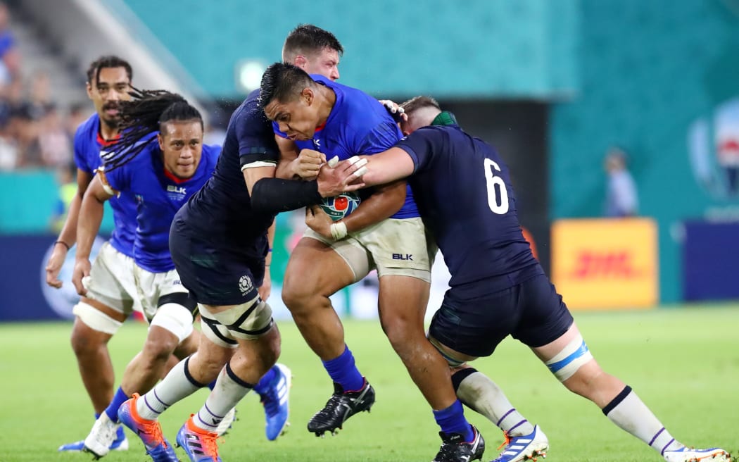 Samoa prop Michael Alaalatoa is tackled by Scotland defenders during their 2019 World Cup pool match in Hyogo, Japan.
