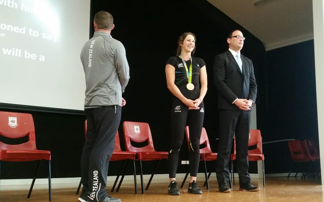 Eliza MCartney (centre) on stage at her old school, Belmont Intermediate.