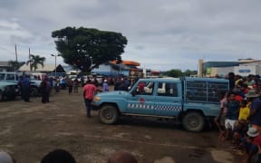 Police contain the crowd gathered at Boroka station.
