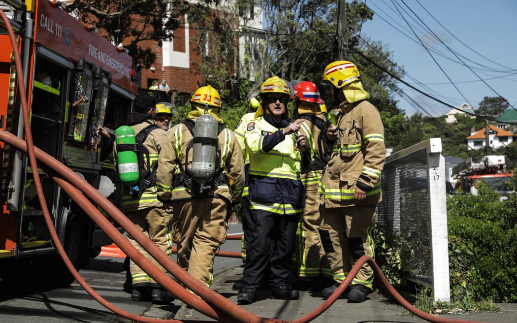 Firefighters attend the scene of a house fire in Kelburn.