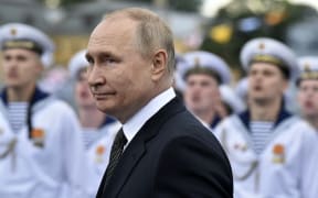 Russia's President Vladimir Putin reviews naval troops as he attends the main naval parade marking the Russian Navy Day, in St. Petersburg on 31 July, 2022.