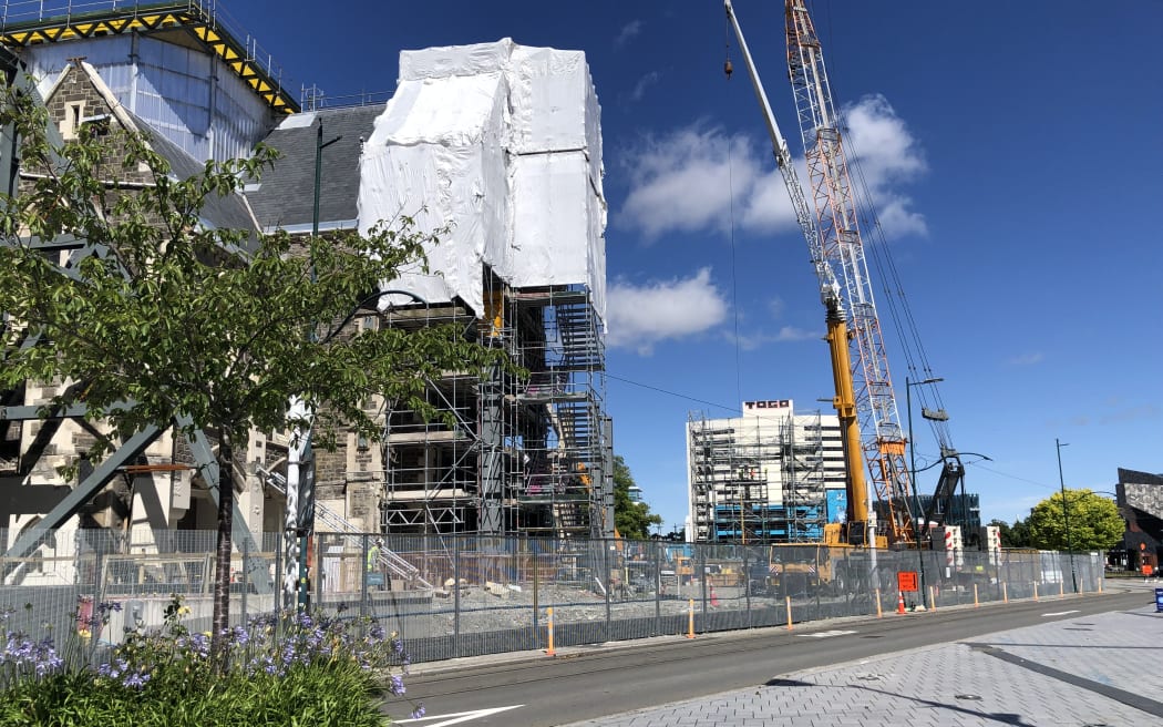 Scaffolding and a crane in front of a building being repaired in a central Christchurch street