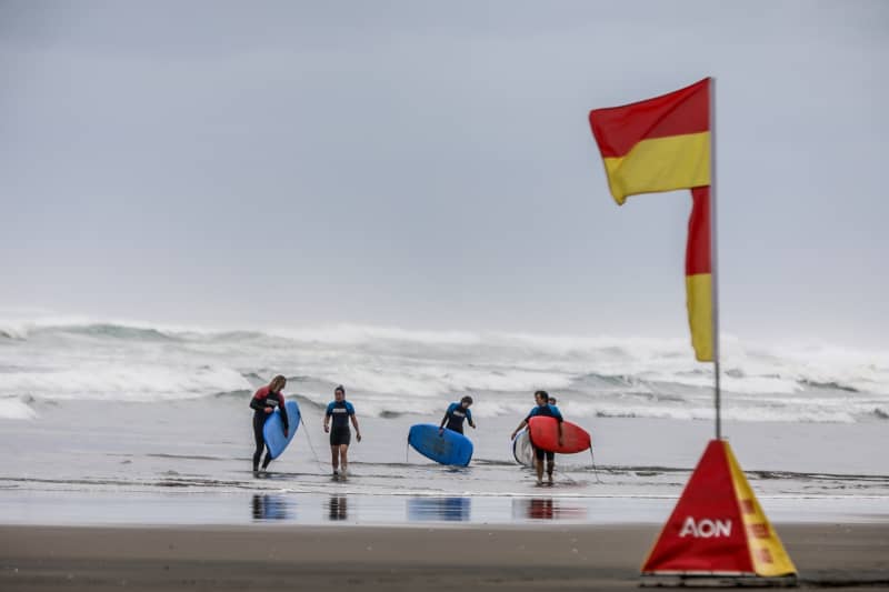 Students learn water safety as well as how to surf