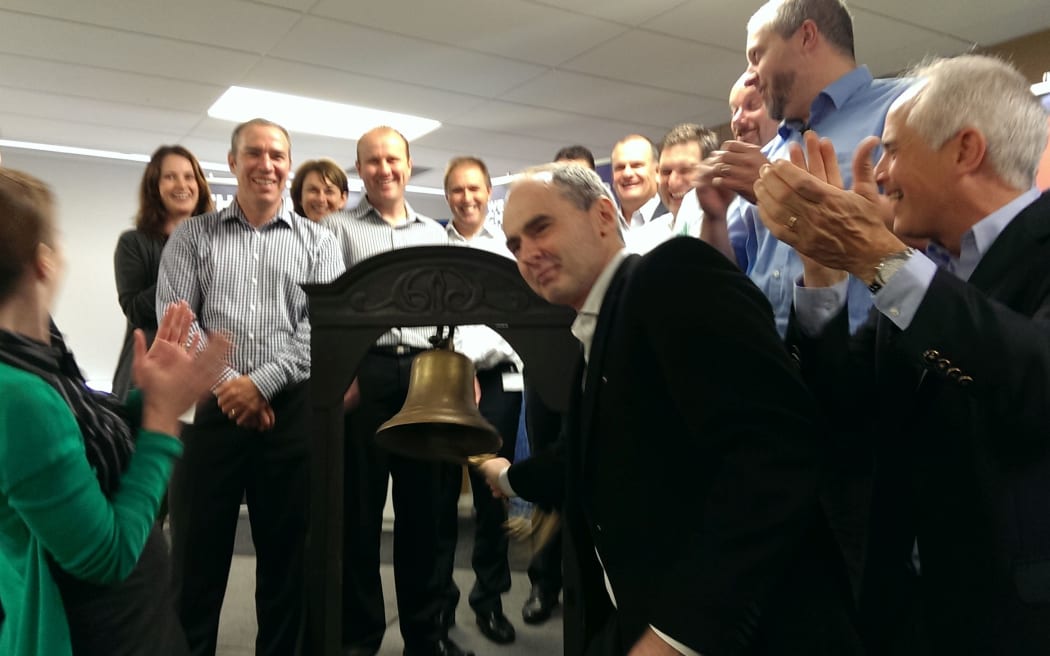 Orion Health chief executive and majority stakeholder, Ian McCrae, rings the bell as the software company launches on the NZX this morning, with Orion chair Andrew Ferrier (right), and surrounded by the executive team.