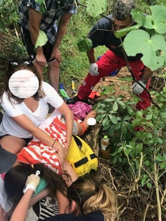 Medical staff stablise the girl after she accidentally impaled her leg on a tree branch.