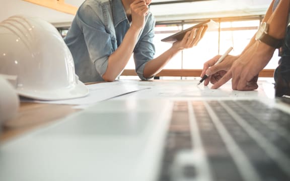 Image of engineer or architectural project, two engineering discussing and working on blueprint with architect equipment, Construction concept.