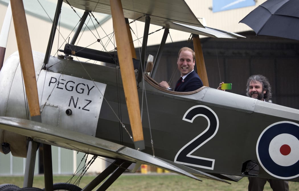 Prince William in the cockpit of a replica Sopwith Pup with Sir Peter Jackson.