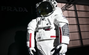 The AxEMU suit is pictured during a press conference of Prada and Axiom Space, as part of the presentation of the Axiom Extravehicular Mobility Unit designed and developed for the Artemis 3 lunar mission in collaboration with Prada, at the MiCo Convention Centre in Milan, northern Italy, on October 16, 2024. - Astronauts walking on the moon as part of NASA's first human mission to the lunar South Pole will be wearing Prada, as part of a new venture unveiled on October 16, 2024. Private space company Axiom Space teamed up with the Italian luxury brand to provide the surface suits and spacewalk systems for NASA's Artemis 3 mission, which is planned for September 2026. (Photo by MARCO BERTORELLO / AFP)