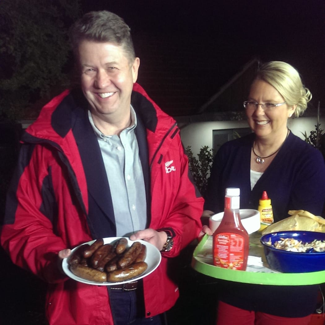 David Cunliffe and and wife Karen Price distribute food to reporters outside their Herne Bay home.