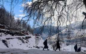 Students on the way to internet during a Kashmir winter.