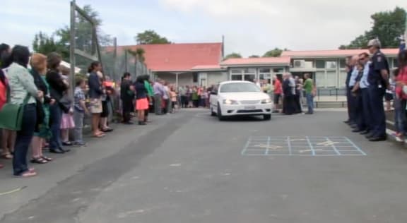 The hearse departs from St Leonards School, while friends are family look on.