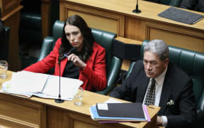 Jacinda Ardern and Winston Peters listen to a question