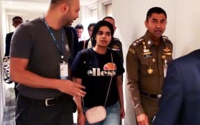 January 7, 2019 18-year-old Saudi woman Rahaf Mohammed al-Qanun (2nd-L) escorted by the Thai immigration officer and United Nations High Commissioner for Refugees (UNHCR) officials at the Suvarnabhumi international airport in Bangkok.