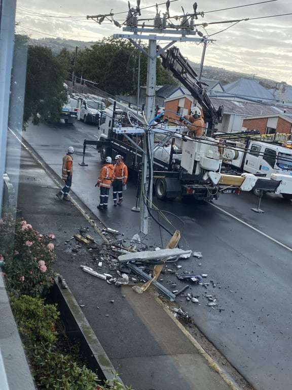 A father and son were in a car which was believed to have been speeding when it slammed into a pole cutting power to hundreds in South Dunedin this morning.