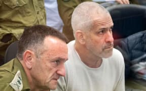 (FILES) This handout picture released by the Israeli army shows (L to R) Israeli army Chief of the General Staff Lieutenant-General Herzi Halevi and Israel Security Agency (ISA, also known as Shin Bet) director Ronen Bar at the Hostages and Missing Persons situation room during the return of the four hostages from Gaza on January 25, 2025. Israeli Prime Minister Benjamin Netanyahu said on March 16 that he was seeking to dismiss the head of Israel's internal security agency, who swiftly called the move political and said the premier expected "personal loyalty". Netanyahu and Shin Bet head Ronen Bar have been engaged in a public spat in recent weeks over reforms to the agency, which has been accused of failing to prevent the October 7, 2023 Hamas attack that triggered war in Gaza. (Photo by Israeli Army / AFP) / === RESTRICTED TO EDITORIAL USE - MANDATORY CREDIT "AFP PHOTO / HANDOUT / ISRAELI ARMY' - NO MARKETING NO ADVERTISING CAMPAIGNS - DISTRIBUTED AS A SERVICE TO CLIENTS ==