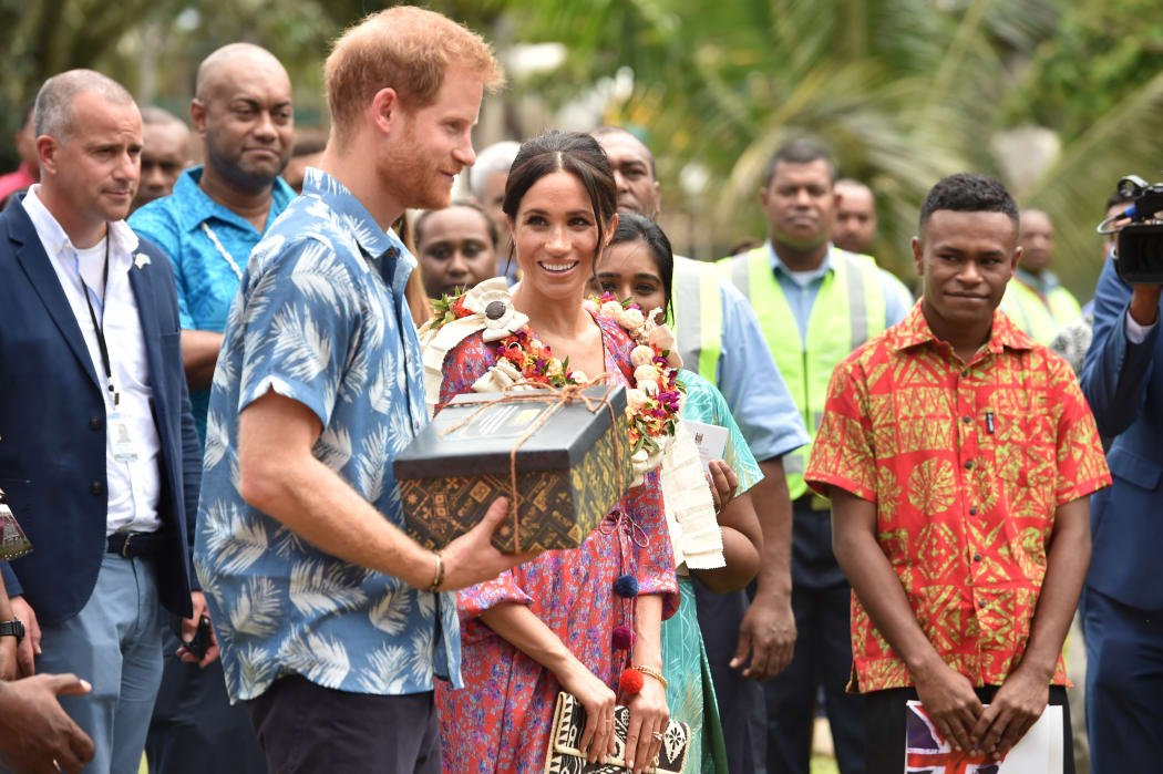 Prince Harry and wife Meghan, Duchess of Sussex, receive a gift from the University of the South Pacific in Suva.