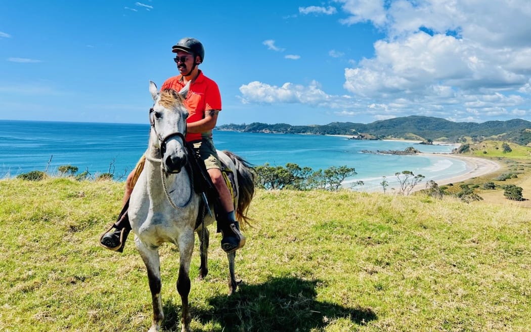 The campground manager at Mimiwhangata, Manaia Armstrong, makes his rounds on horseback.