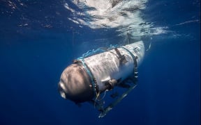 This undated image courtesy of OceanGate Expeditions, shows their Titan submersible beginning a descent. Rescue teams expanded their search underwater on June 20, 2023, as they raced against time to find a Titan deep-diving tourist submersible that went missing near the wreck of the Titanic with five people on board and limited oxygen. All communication was lost with the 21-foot (6.5-meter) Titan craft during a descent June 18 to the Titanic, which sits at a depth of crushing pressure more than two miles (nearly four kilometers) below the surface of the North Atlantic. (Photo by Handout / OceanGate Expeditions / AFP) / RESTRICTED TO EDITORIAL USE - MANDATORY CREDIT "AFP PHOTO / OceanGate Expeditions" - NO MARKETING NO ADVERTISING CAMPAIGNS - DISTRIBUTED AS A SERVICE TO CLIENTS