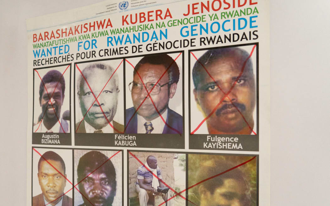 Fulgence Kayishema (top row R) is seen on a wanted poster on the wall at the Genocide Fugitive Tracking Unit office, in Gishushu, in Kigali on May 25, 2023. Fulgence Kayishema, one of the last four fugitives sought for their role in the 1994 Rwanda genocide, has been arrested in South Africa, UN investigators said on May 25, 2023. (Photo by Mariam KONE / AFP)