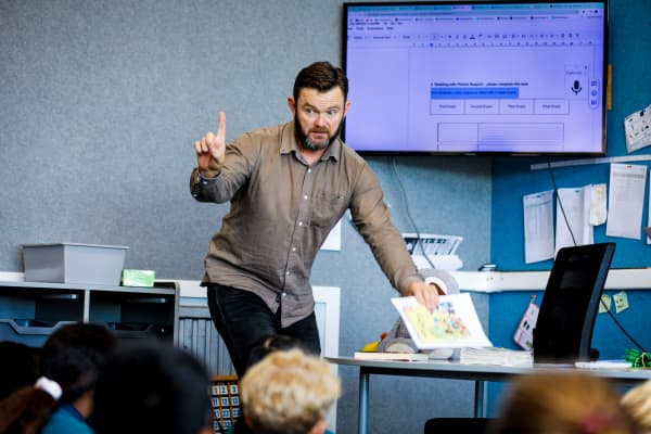 Phillip King, a teacher at Oranga School, working in the classroom that he leads with 9 and 10 year old students.