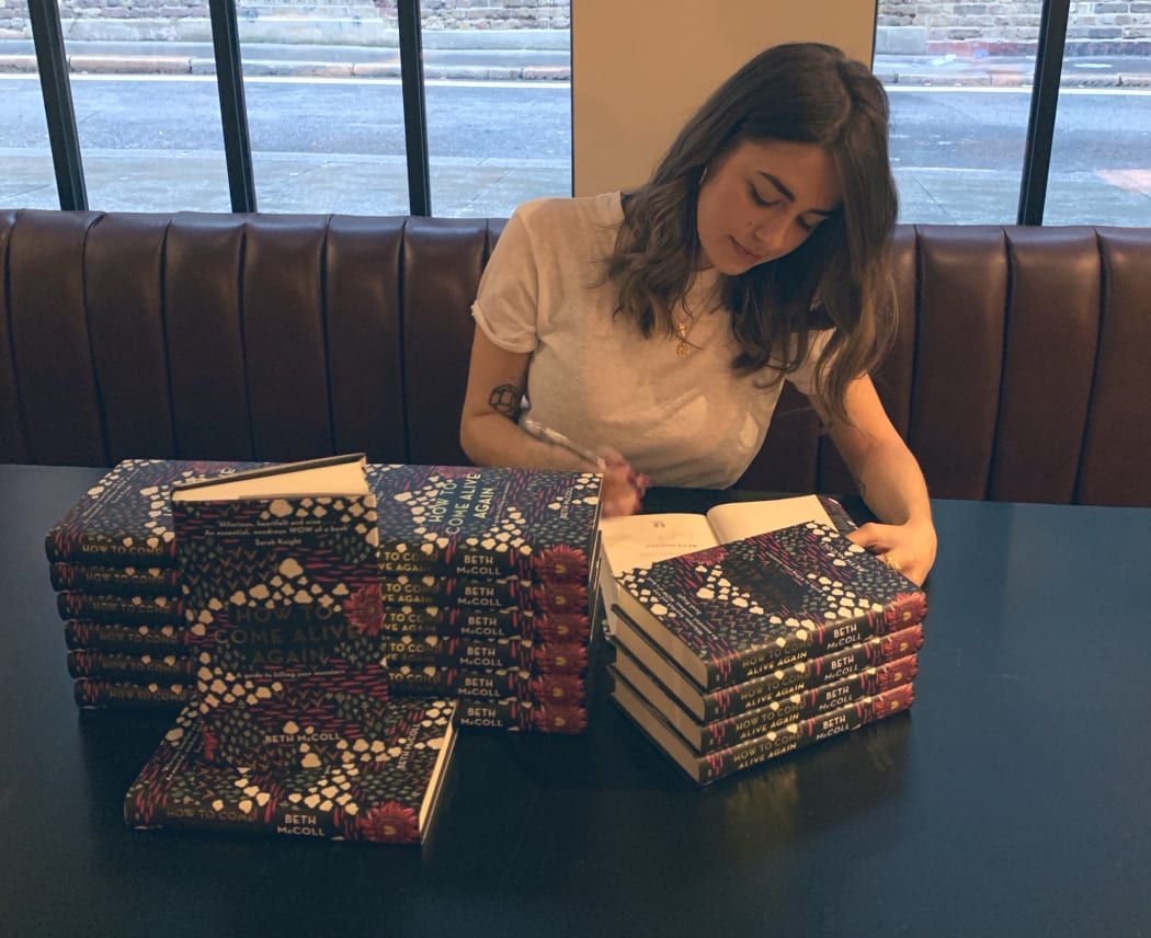 Beth McColl signin copies of her book, How to Come Alive Again