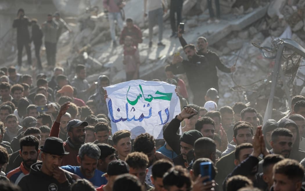 A protester carries a sign that reads "Hamas does not represent us".