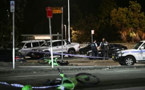 Police work at the scene after a shooting incident at Bondi Beach in Sydney on 14 December 2025. Two gunmen opened fire at Sydney's Bondi Beach on December 14, killing 11 people and wounding multiple others in a "terrorist incident" during a gathering for the Jewish festival of Hanukkah.