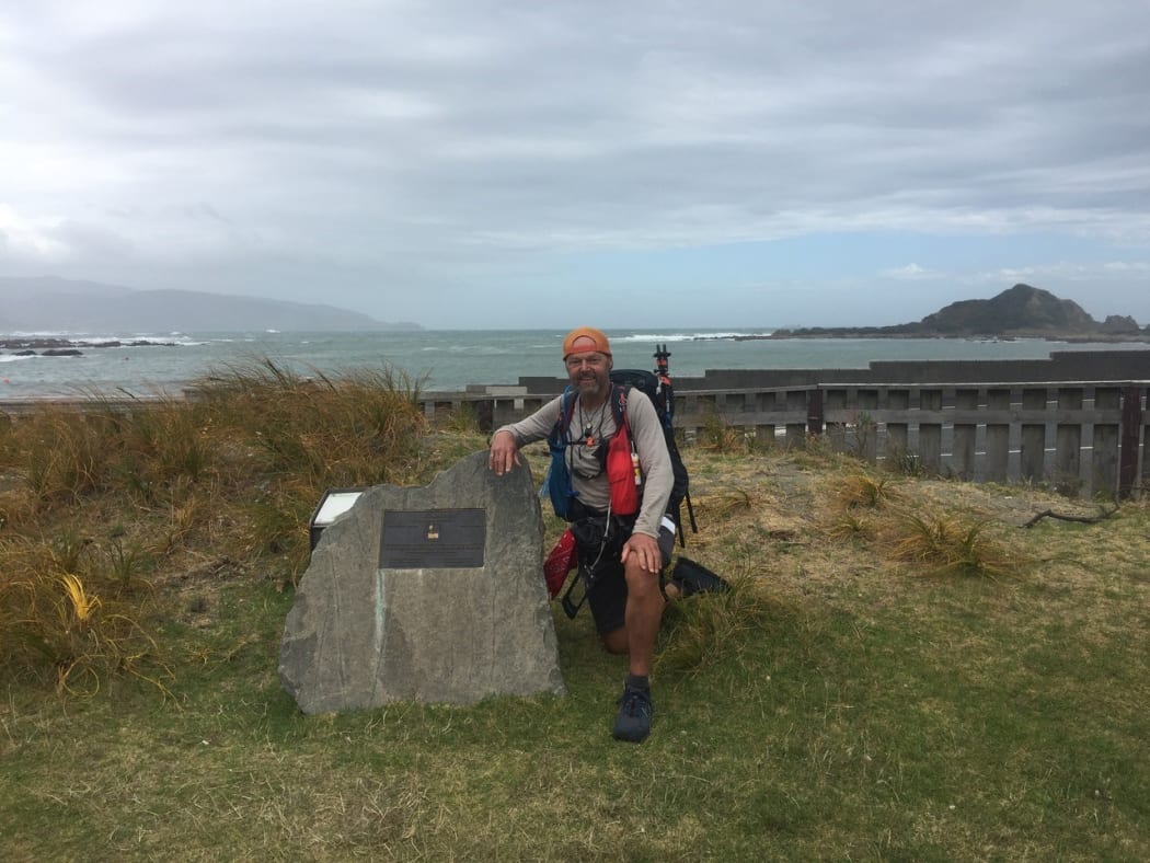 Bruce poses beside a stone marking the official end of the North Island section of Te Araroa - New Zealand's trail.