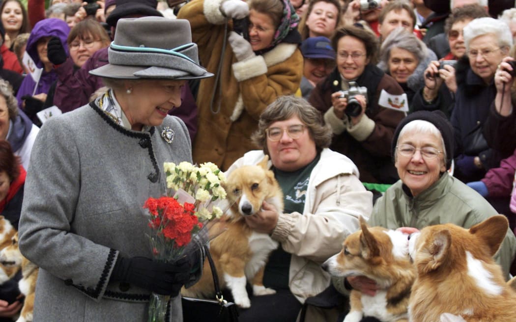 Queen Elizabeth II talks with members of the Manitoba Corgi Association during a visit to Winnipeg, Canada on 8 October 2002.
