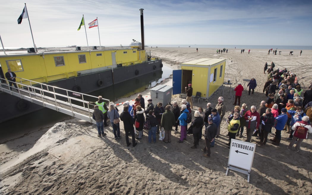 Voters queue at a polling station in  Marker Wadden, Lelystad.