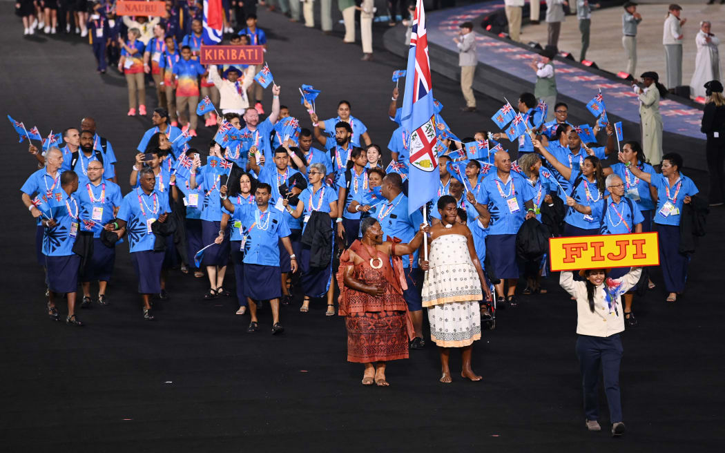 Fiji's flag bearers Semesa Naiseruvati and Naibili Vatunisolo and teammates take part in the opening ceremony for the Commonwealth Games at the Alexander Stadium in Birmingham, central England, on July 28, 2022. (Photo by Glyn KIRK / AFP)