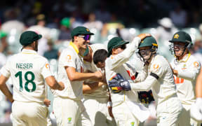 ADELAIDE, AUSTRALIA - DECEMBER 18: Alex Carey of Australia is congratulated by his team mates after taking a catch during day two of the Third Test Match in the 2025/26 Ashes Series between Australia and England at Adelaide Oval on December 18, 2025 in Adelaide, Australia. (Photo by Santanu Banik/MB Media/Getty Images)