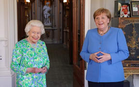 Britain's Queen Elizabeth II receives German Chancellor Angela Merkel during an audience at Windsor Castle in Windsor, Berkshire on July 2, 2021.