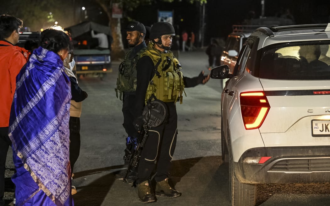 An Indian Army personnel stops a car for inspection near Pahalgam, south of Srinagar, on April 22, 2025, following an attack. At least 24 people were killed in Indian-administered Kashmir when gunmen opened fire on tourists on April 22, a senior police officer told AFP, with authorities calling it the worst attack on civilians in years. Prime Minister Narendra Modi decried the "heinous act" in the summer retreat of Pahalgam, pledging the attackers "will be brought to justice". (Photo by TAUSEEF MUSTAFA / AFP)