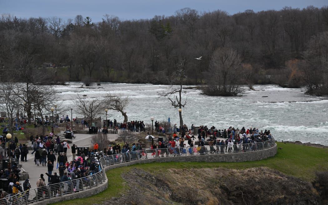 People gather at Niagara Falls State Park ahead of a total solar eclipse across North America, in Niagara Falls, New York, on April 8, 2024.