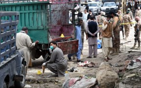 Pakistani security officials inspect the site of a bomb blast at a fruit market in Quetta on April 12, 2019. At least 16 people were killed and 30 wounded in a powerful blast on April 12.