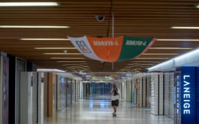 An umbrella is hung to block a CCTV camera in a shopping mall in Tai Po district during a general strike in Hong Kong on August 5, 2019.