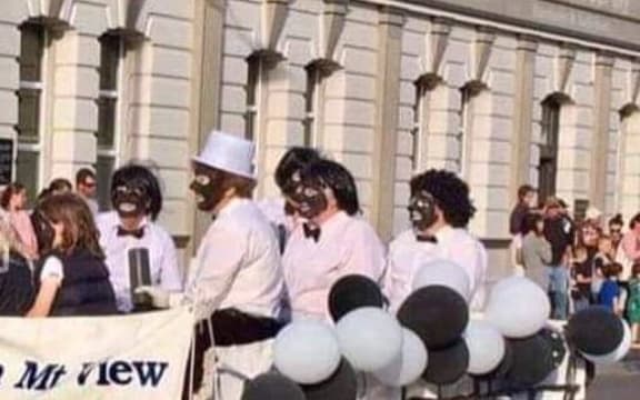 A Lions Club Christmas parade float featuring adults and children in black face, Hawera, 2018.
