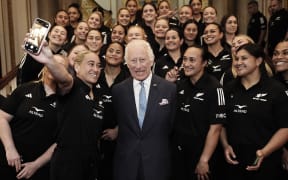 Britain's King Charles III poses for a photograph with members of New Zealand's Black Ferns rugby team at Buckingham Palace, 2024.