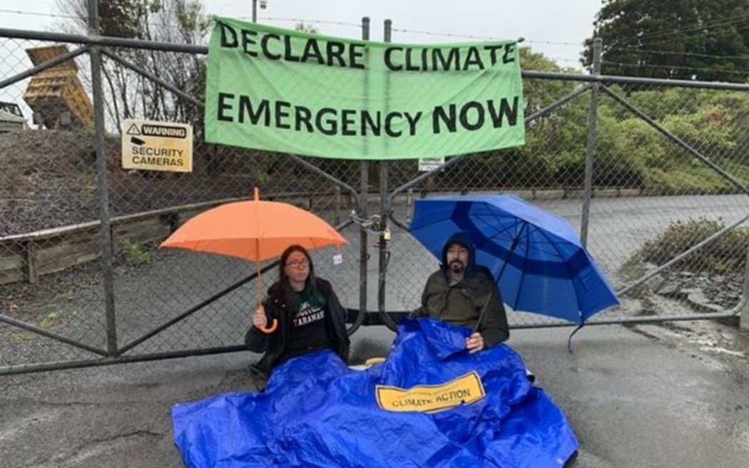 Two protesters outside the Rotowaro open-cast coal mine near Huntly.