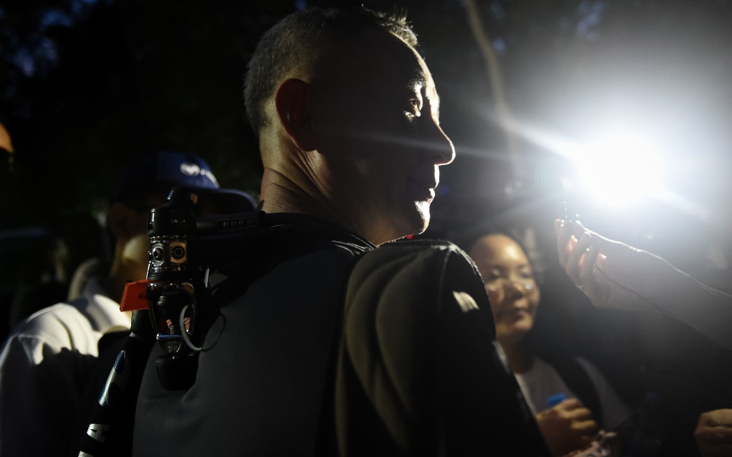 A Chinese diver talks to media at the Tham Luang cave.