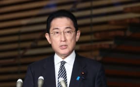 Japanese Prime Minister Fumio Kishida speaks to reporters after the Lower House approved a record 107.60 trillion yen ($900 billion) budget for fiscal 2022 at the prime minister's office in Tokyo on March 22, 2022.