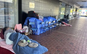 Rough sleepers and their possessions outside the Salvation Army store on Amohia Street.