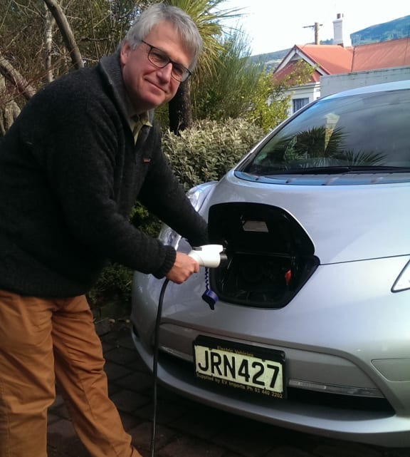 Henrik Moller plugs in his electric vehicle
