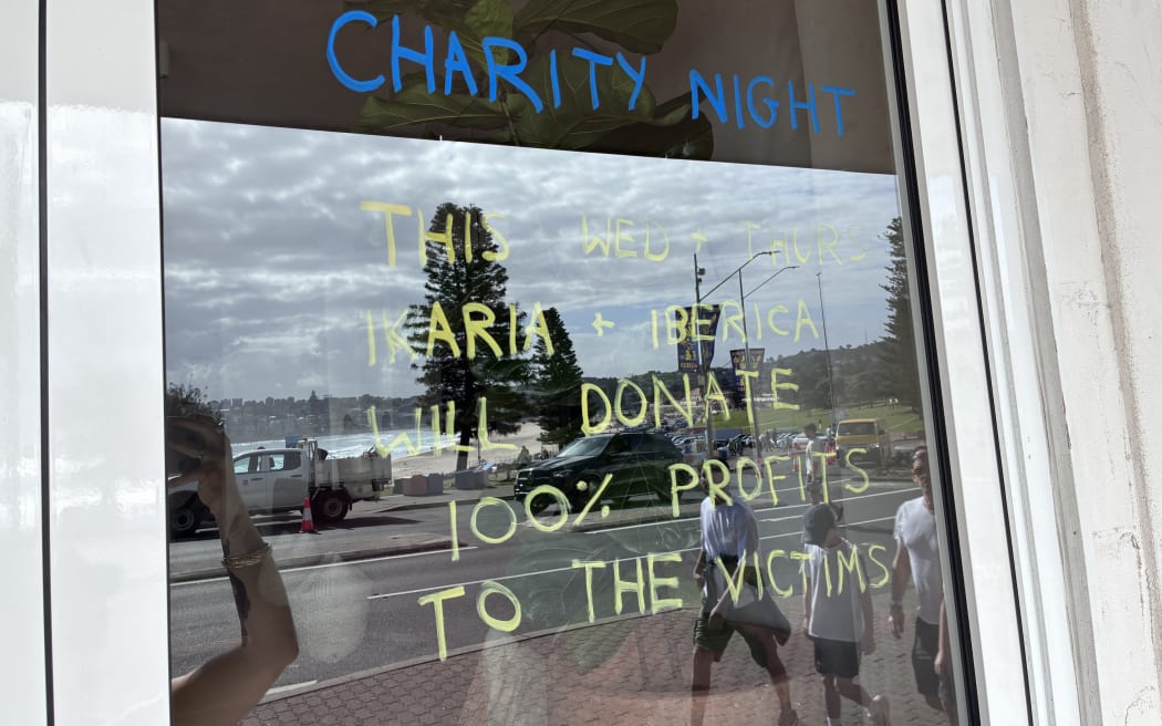 Signs in windows on 17 December after the attack at Bondi Beach where 15 people were killed.