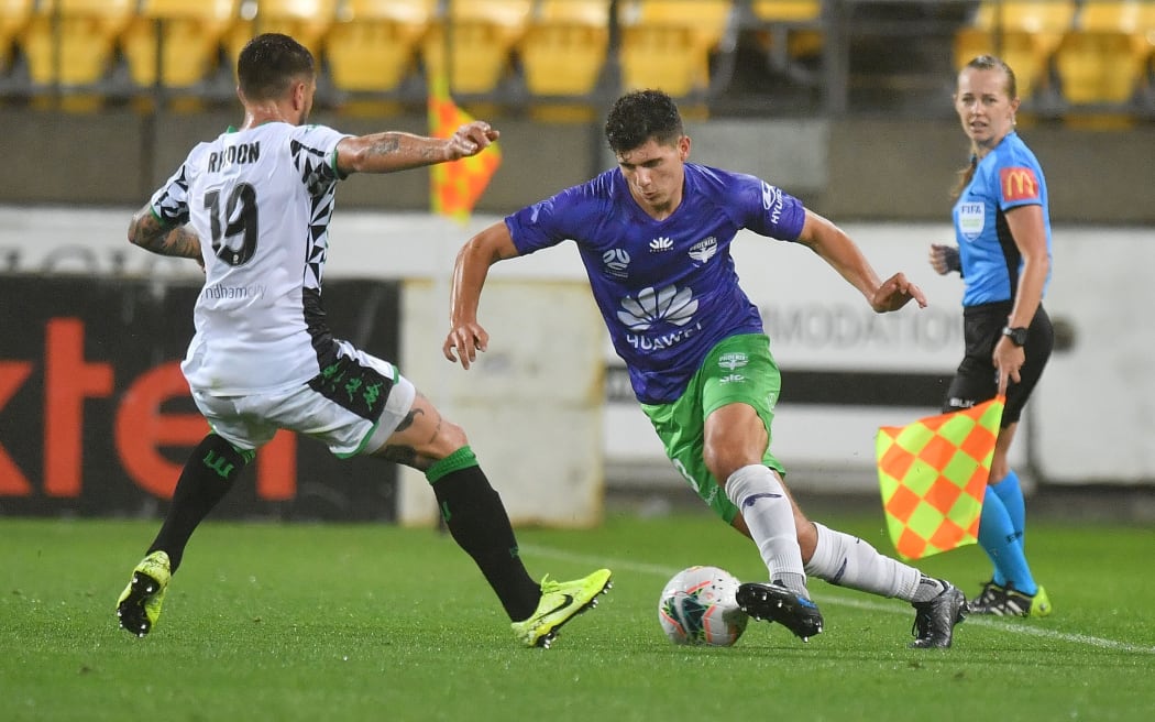 Phoenix's Liberato Cacace (R dribbles the ball with Western's Josh Risdon during the A-League - Phoenix v Western United football match at Sky Stadium in Wellington on Friday the 21st February 2020. Copyright Photo by Marty Melville / www.Photosport.nz