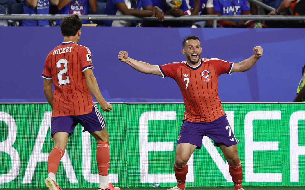 Scotland’s midfielder John McGinn (No 7) celebrates with teammate defender Aaron Hickey after scoring his team’s first goal during the 2026 World Cup Group C football match against Haiti in Boston, June 13, 2026. (Photo by FRANCK FIFE / AFP)