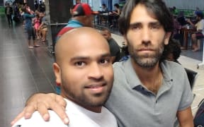 Shaminda Kanapathi farewells Behrouz Boochani at Port Moresby's airport.