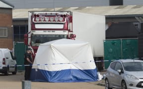 Police officers work at the scene where 39 bodies were found in a shipping container at Waterglade Industrial Park in Essex, Britain, on Oct. 23, 2019.