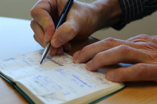 University of Auckland professor of chemical sciences Paul Kilmartin writes by hand in a filled diary entry.